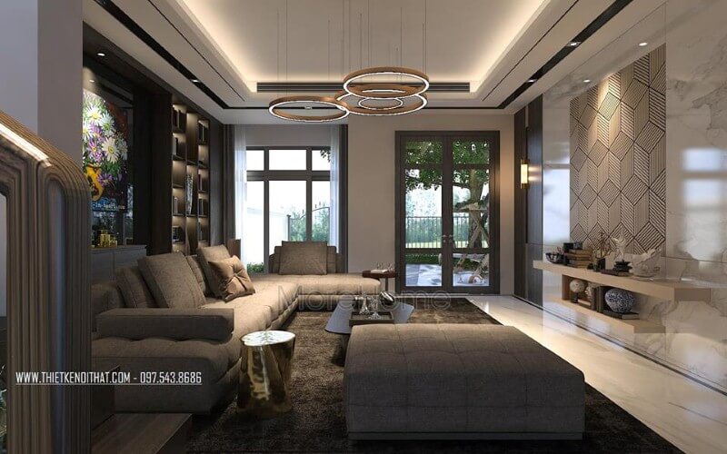 Thiết kế nội thất phòng khách ấn tượng với cách kết hợp hài hòa giữa sắc trầm và sáng cùng hệ cửa kính lớn giúp không gian trở nên thông thoáng, sang trọng. Mẫu nội thất biệt thự đẹp